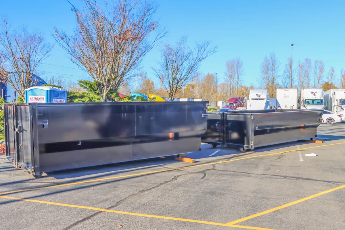 Professional dumpster rental service with roll-off container on residential driveway in Delhi