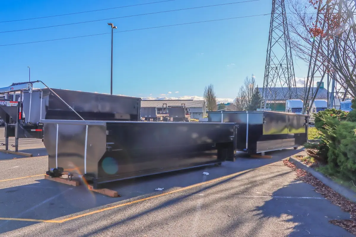 Roll-off dumpster ready for waste disposal at job site for Concrete Dumpster Rental in Delhi